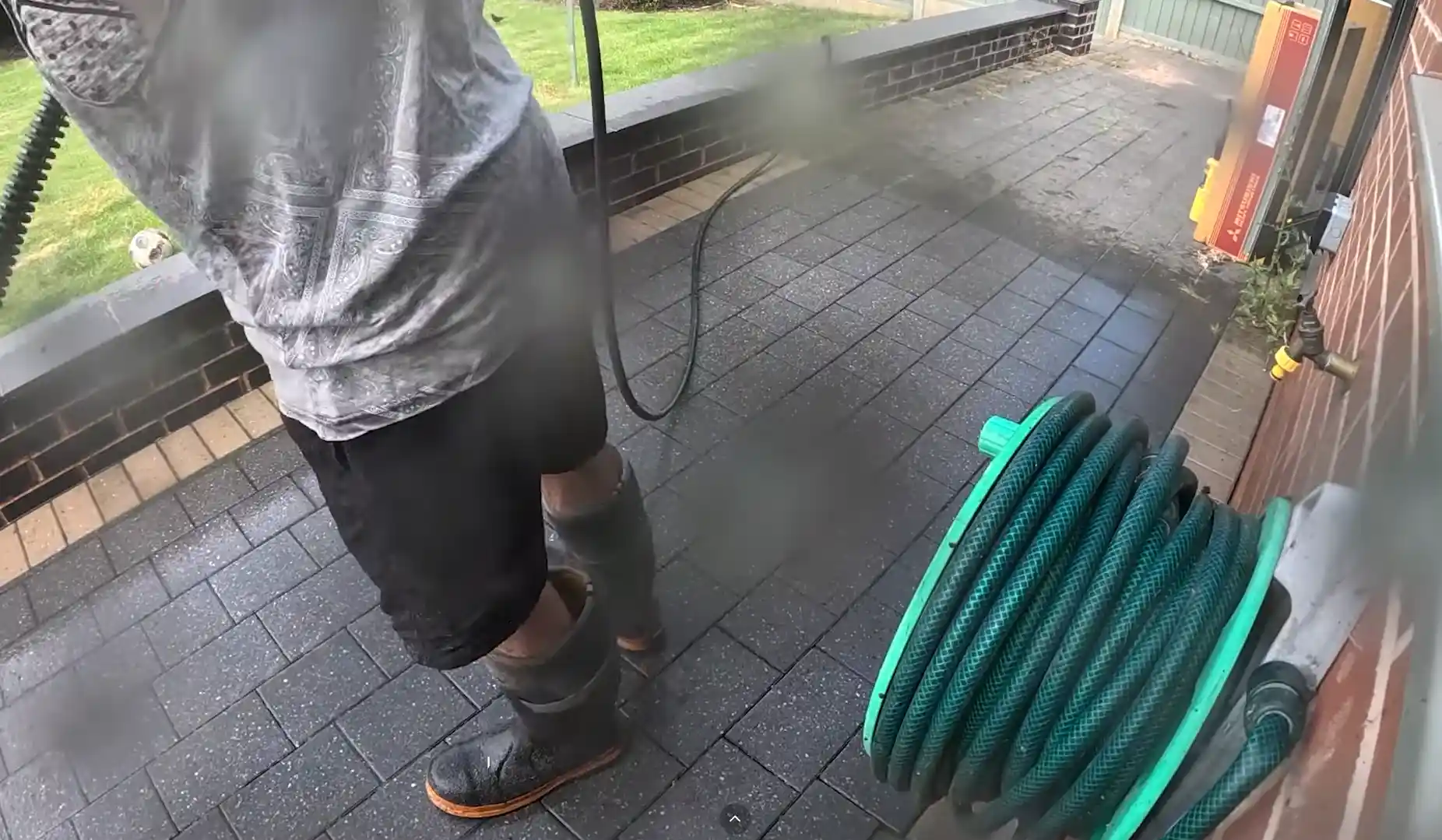 Soft washing an exterior wall in Tampa, FL